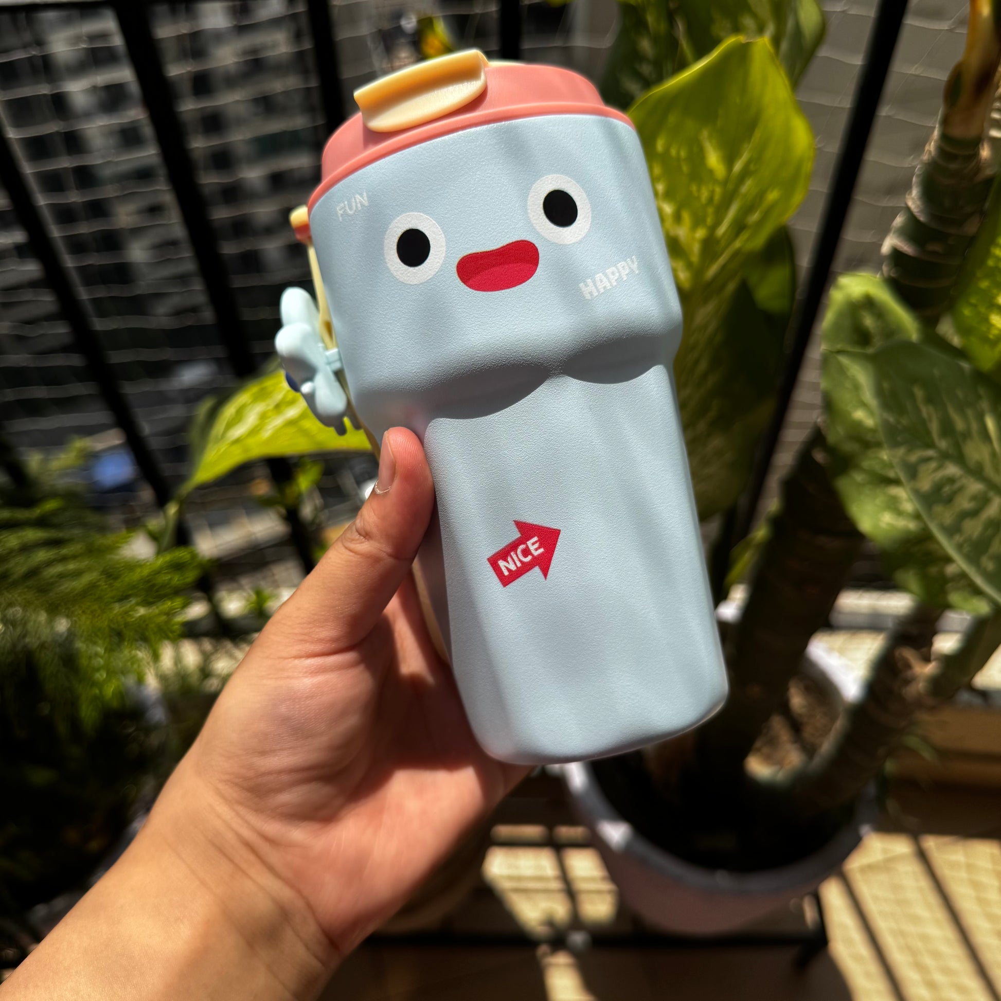 Blue sipper bottle with a relaxing smiley face design