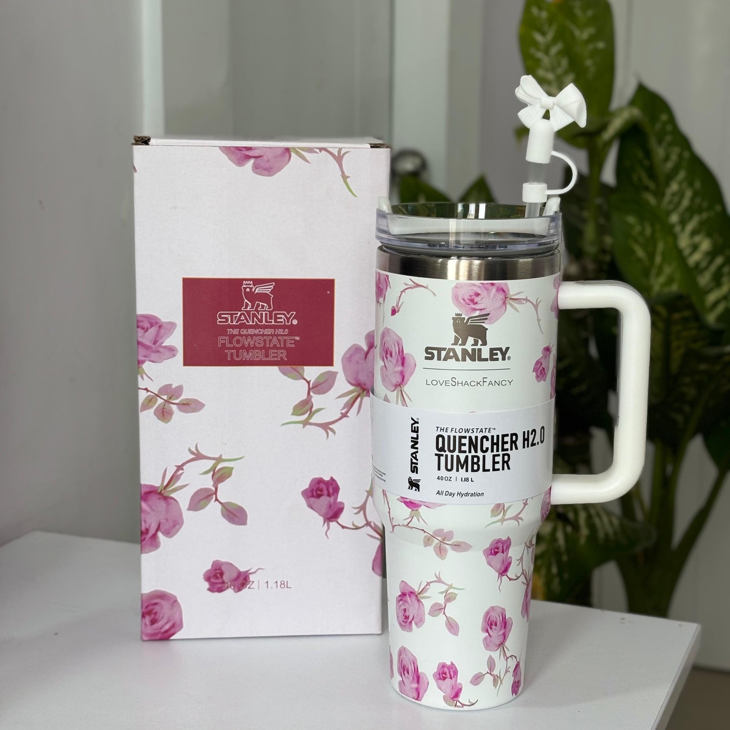 Stanley insulated tumbler placed on a table with box and ambient background
